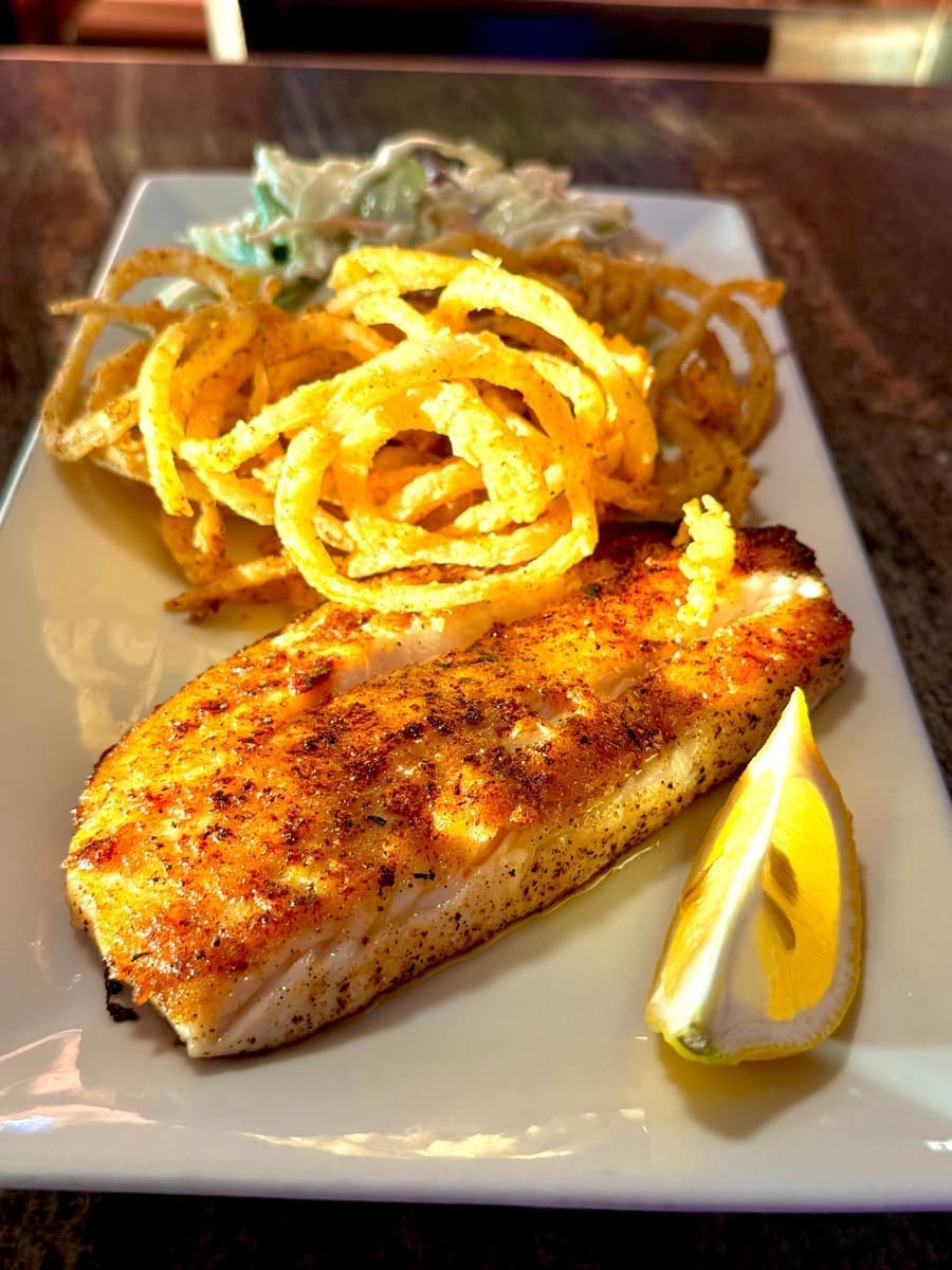 Grilled flounder topped with crispy onion straws